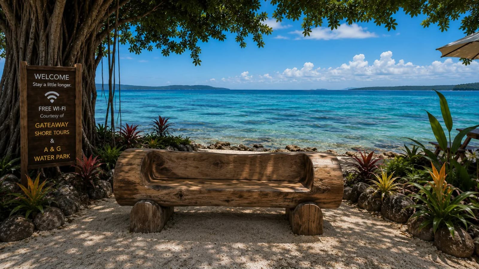 Carved log bench in the shade looking across Fatumaru Bay toward distant islands.