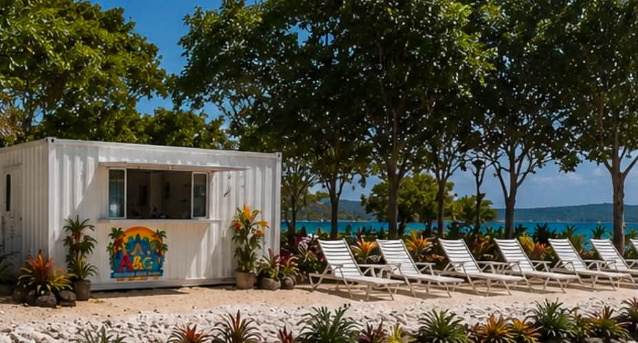 White lounge chairs under trees beside the water park kiosk, looking out to Fatumaru Bay.